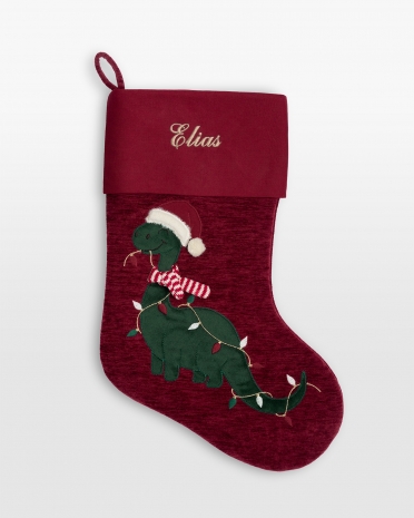 Julstrumpa med broderat namn och ett motiv av en julig dinosaurie