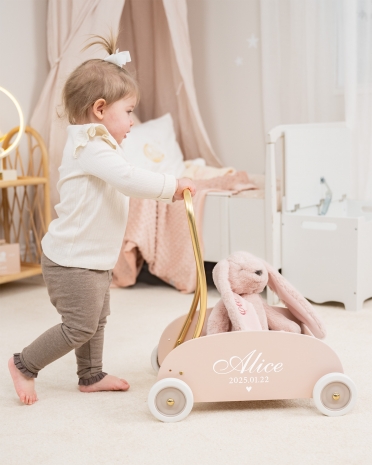 Rosa lära-gå-vagn med namn och födelsedatum