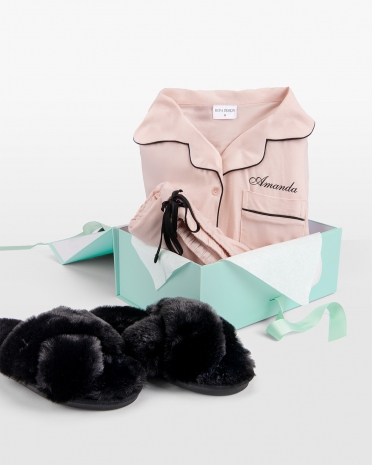 rosa pyjamas med namn och svarta tofflor i presentlåda
