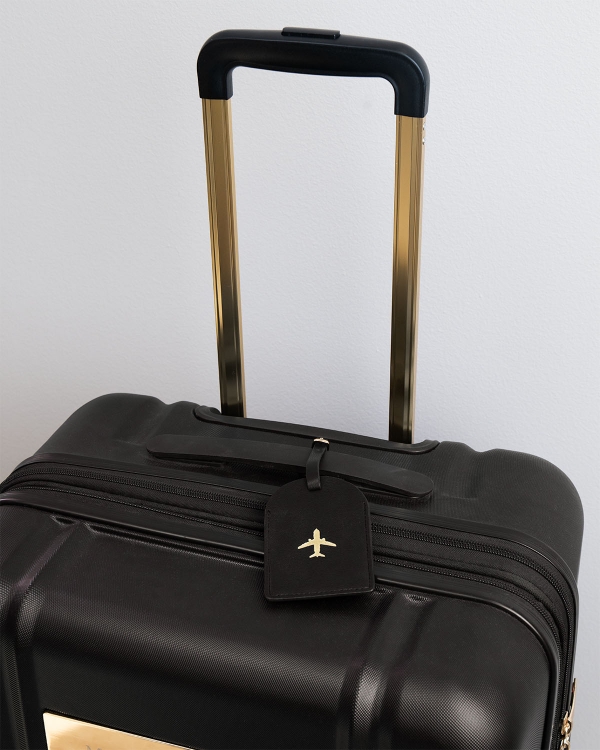 adresslapp till resväska i svart med gulddetaljer