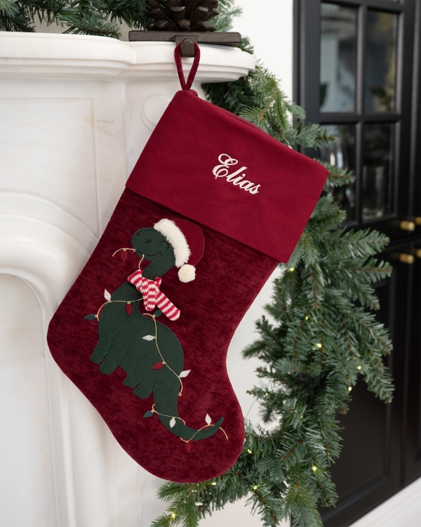 Röd julstrumpa med dinomotiv, kommer personligt broderad