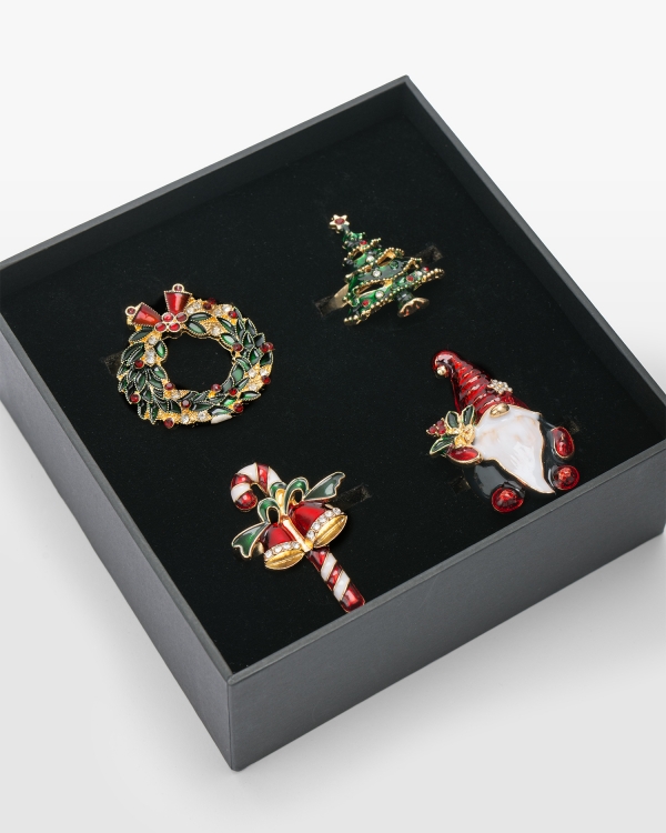 4-pack guldfärgade servettringar med olika julmotiv i presentask