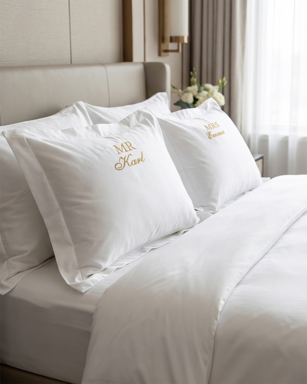 Vitt påslakanset med broderad text till brudparet