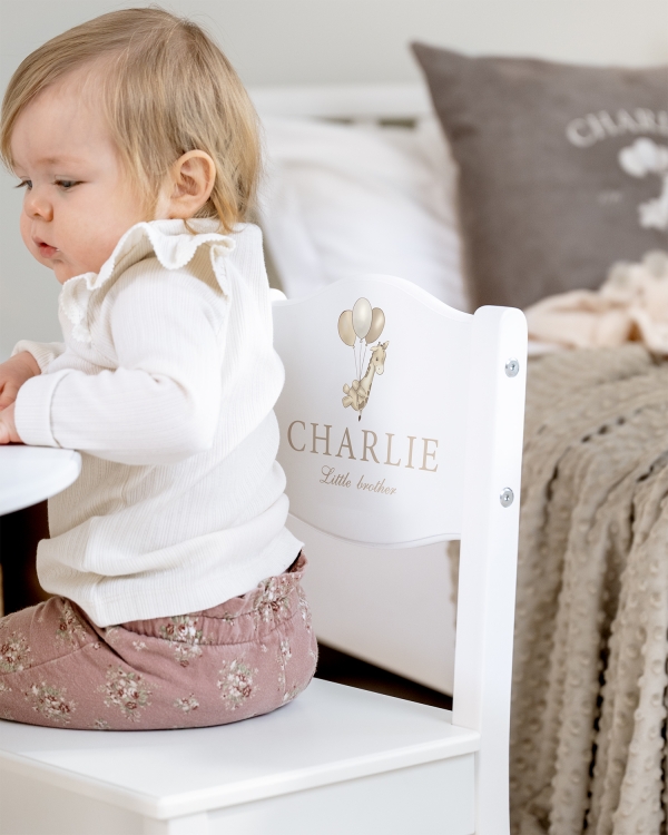 Vit barnstol med olika giraffmotiv samt namn